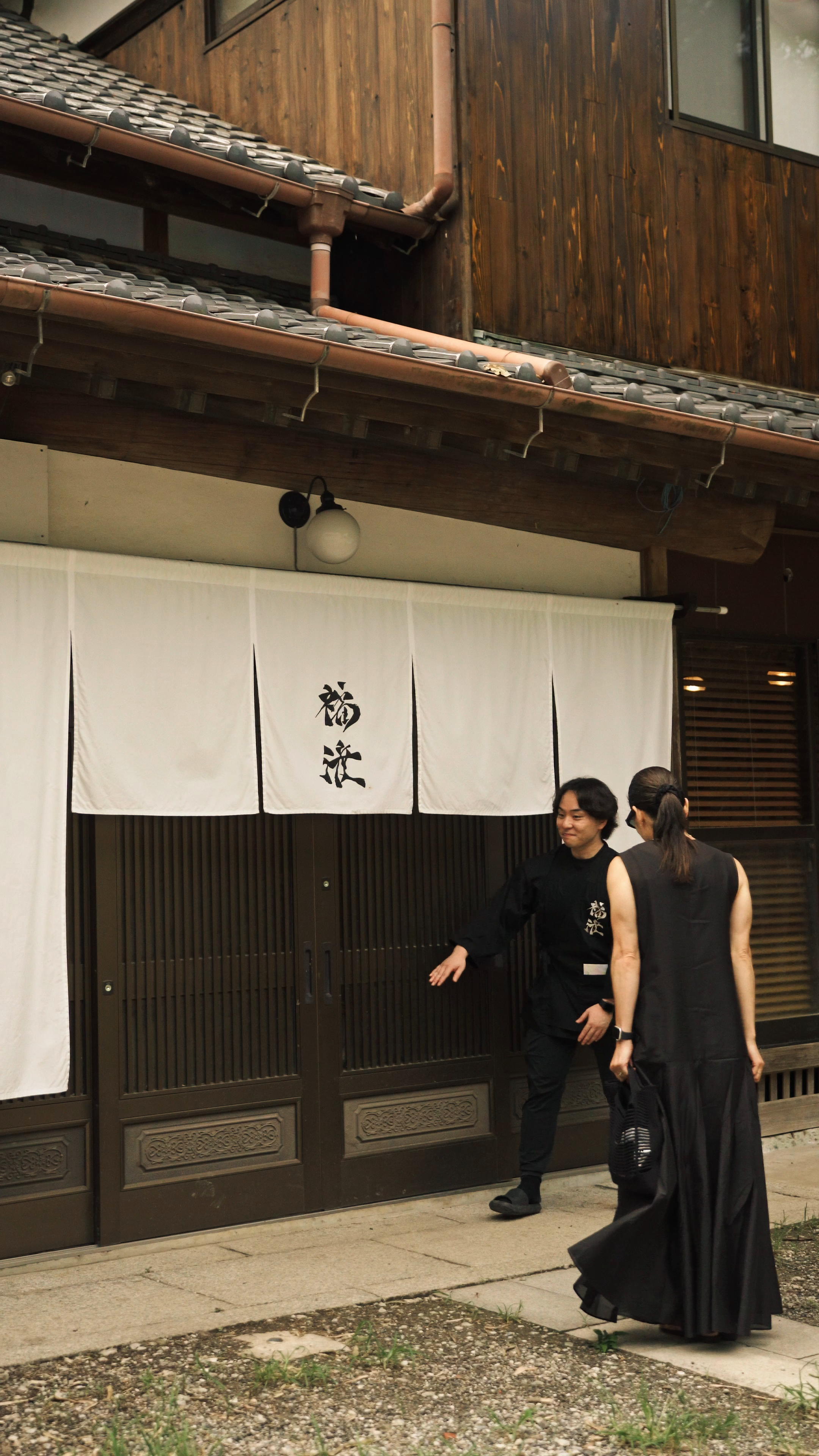 Guests being welcomed by a member of the team at the Fukuwatari residence entrance