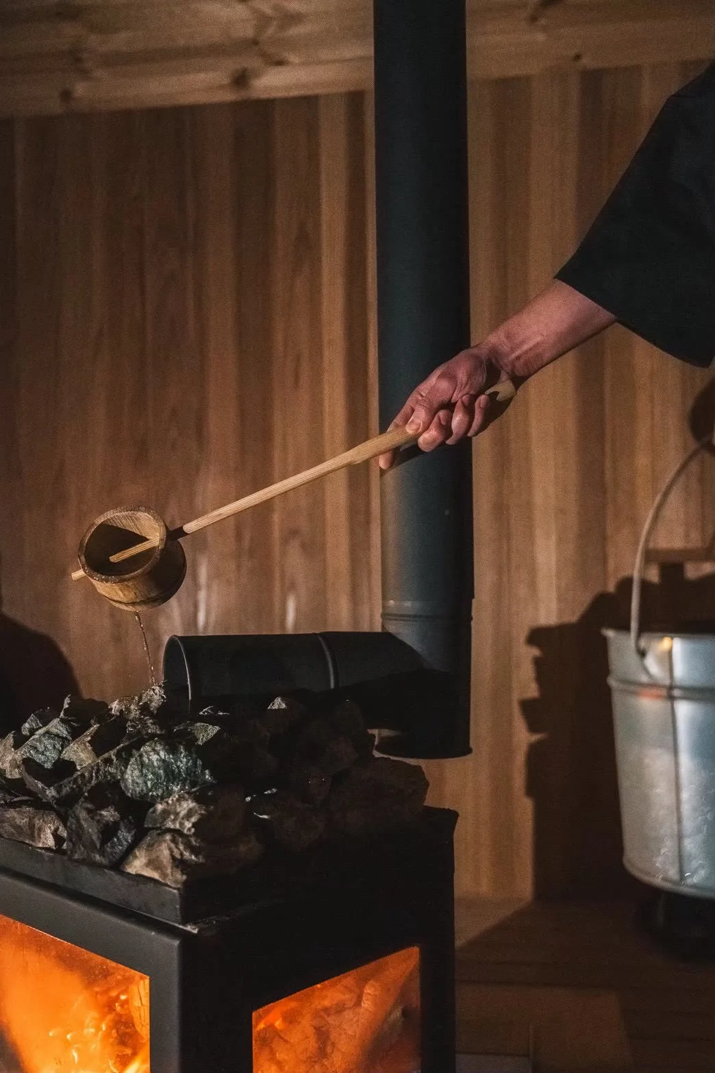 Water being poured over hot stones in the wood-fired sauna at Fukuwatari Tei