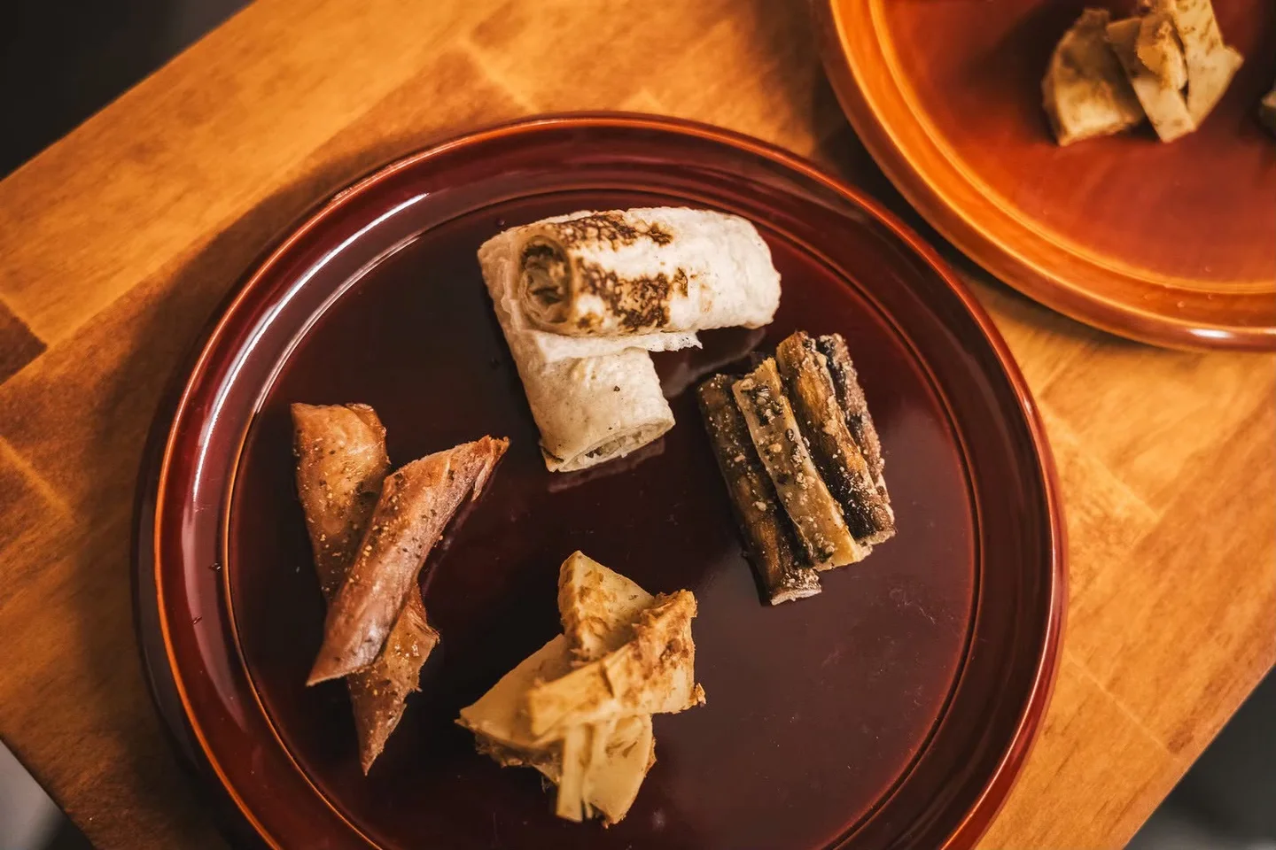 A selection of Japanese bites served on a lacquer plate at Fukuwatari Tei